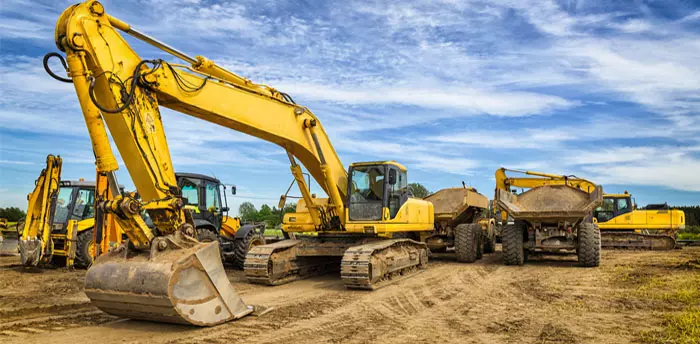 Site Road Plan Review, photo of earth-moving and digging construction equipment at a job site, blue sky