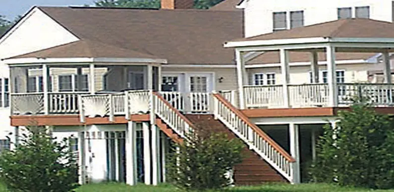 Top floor deck with covered areas and a staircase to the yard
