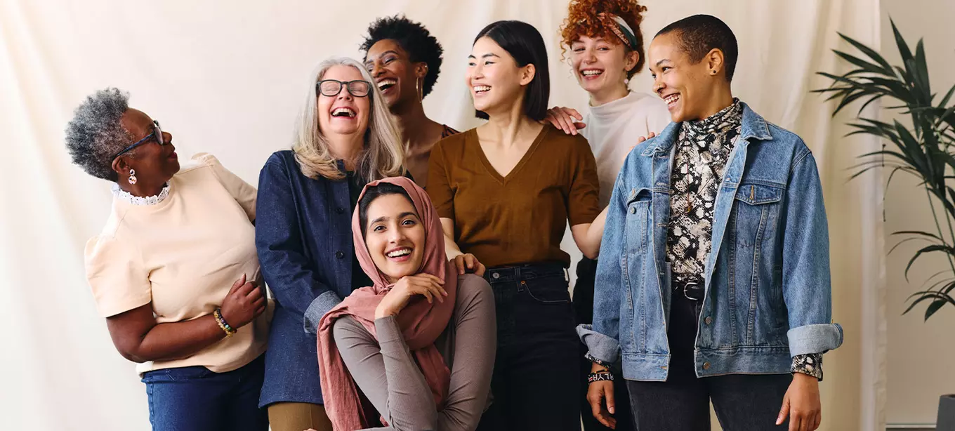 Group of women of different ages and ethnicities smiling and laughing