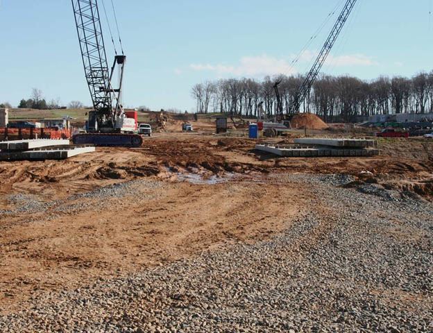 Site Road construction, dirt foundation for road, construction equipment, gravel
