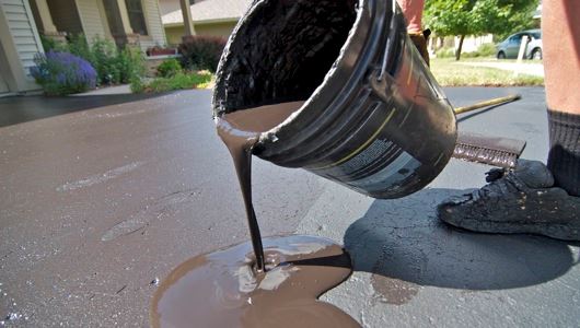 Pouring Seal Coating on Driveway