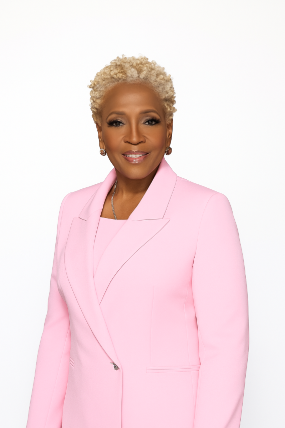 Alice Williams standing up in pink suite