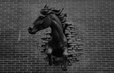 horse statue jumping through bricks