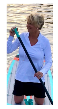lady in a boat in the lake holding a paddle