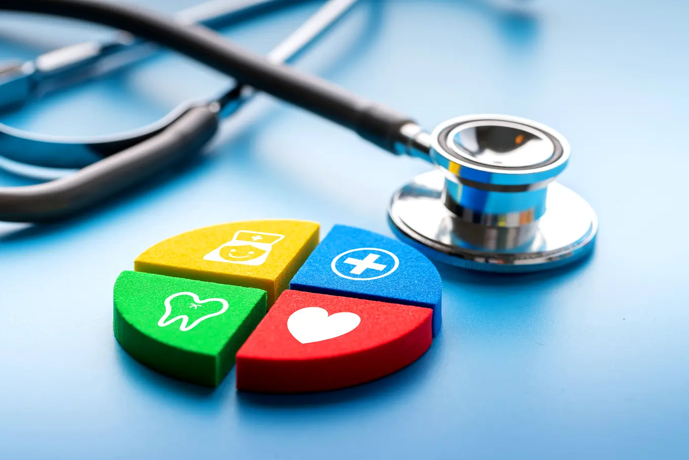 4 colorful blocks of yellow, blue, green, and red with icons depicting medical services.