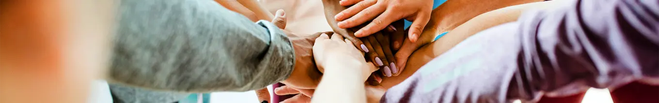Group of people touching hands. 