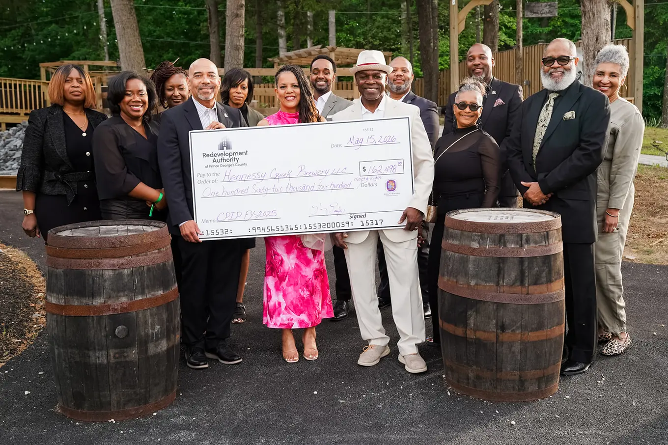 multiple individuals surrounding a check for the Hennessey Creek Brewery