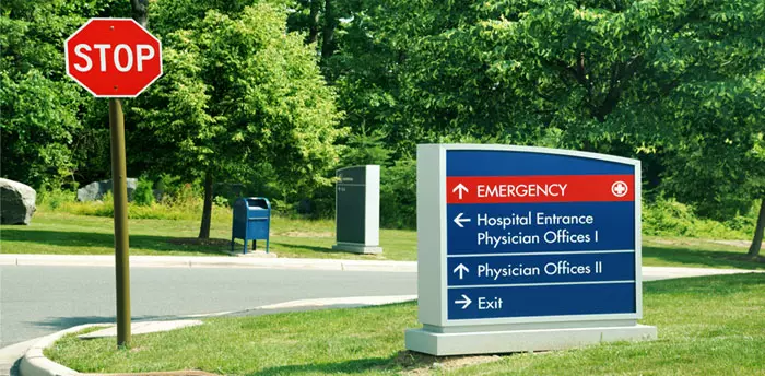 Hospital pedestal-mounted outdoor directional sign