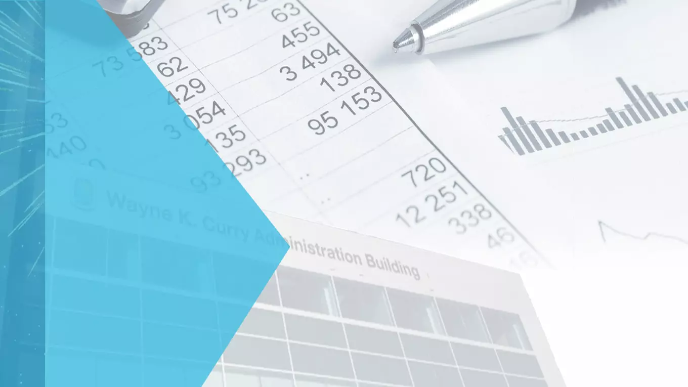 pen, calculator, and County administration building