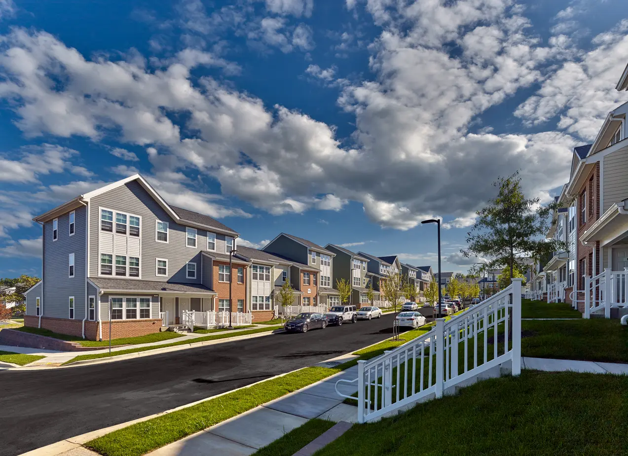 Street-view wide shot of multi-family townhomes 