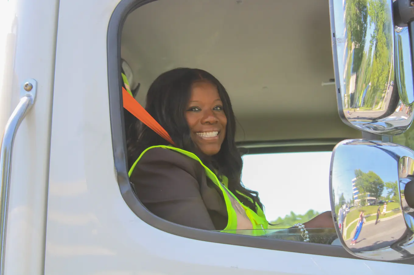 County Executive Braveboy smiling in the driver's seat of a County street sweeper
