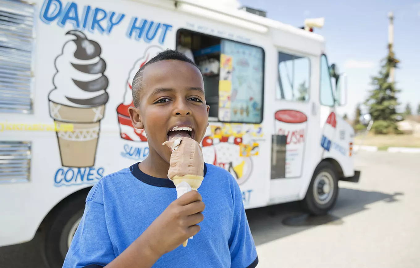Ice Cream truck with young boy enjoying an ice cream cone