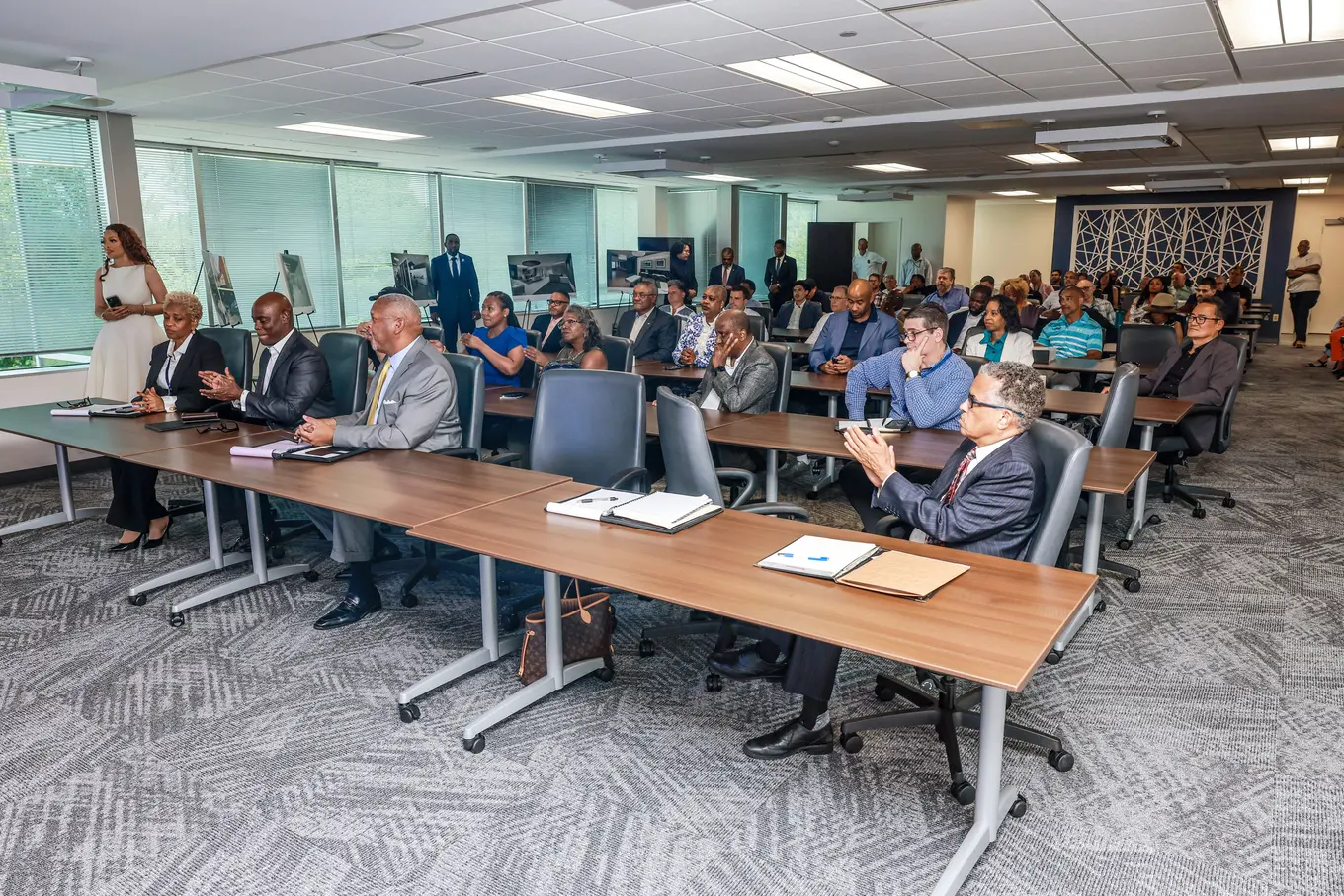 A meeting room with a lot of individuals from Central Services in it