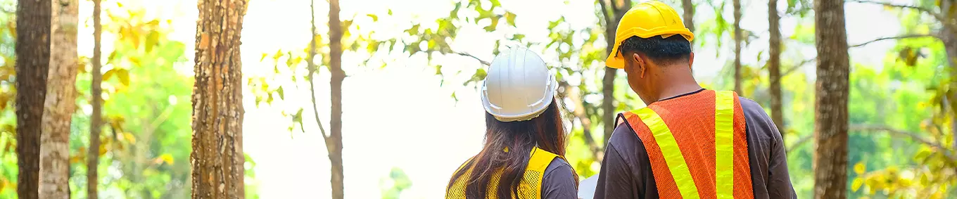 A photo of two environmental engineers in the woods.