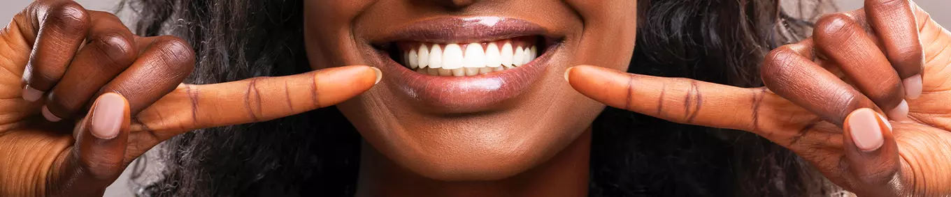 A black woman showing off her beautiful smile.