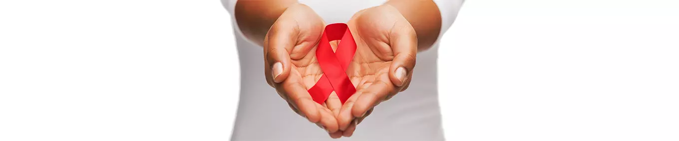 A black woman holding the red HIV/AIDS ribbon.