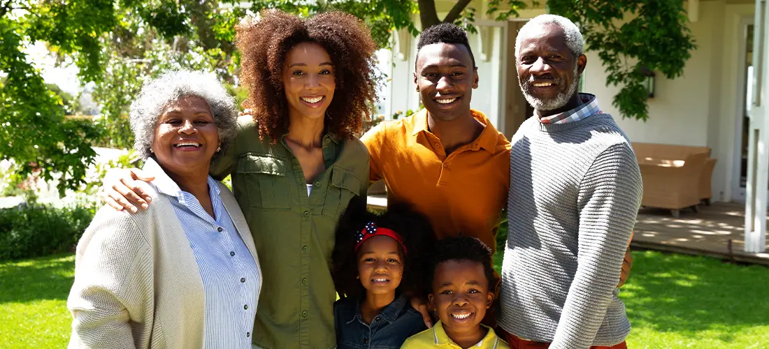 Family standing together outside. 