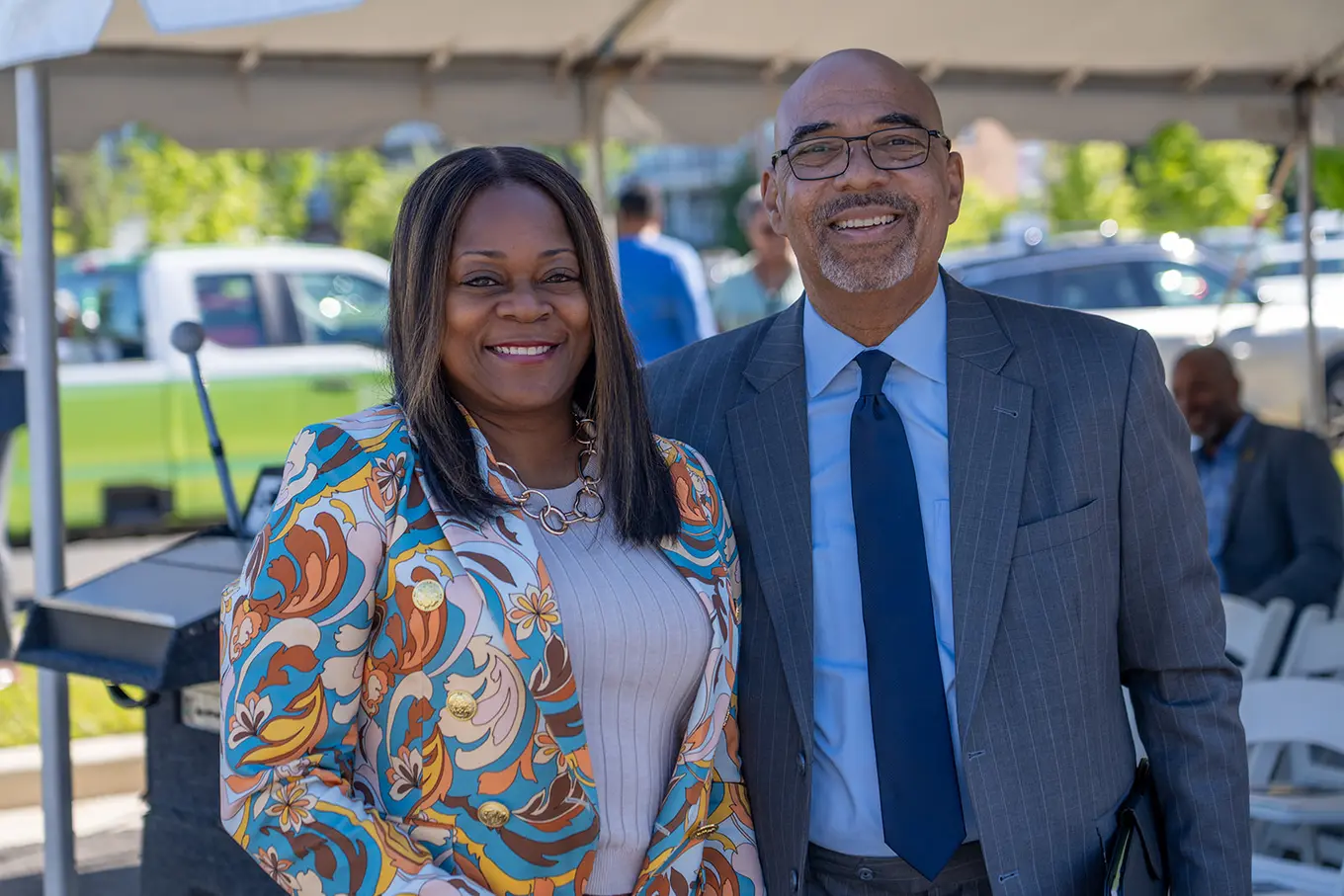 Executive Director Perry Paylor taking a picture with a woman