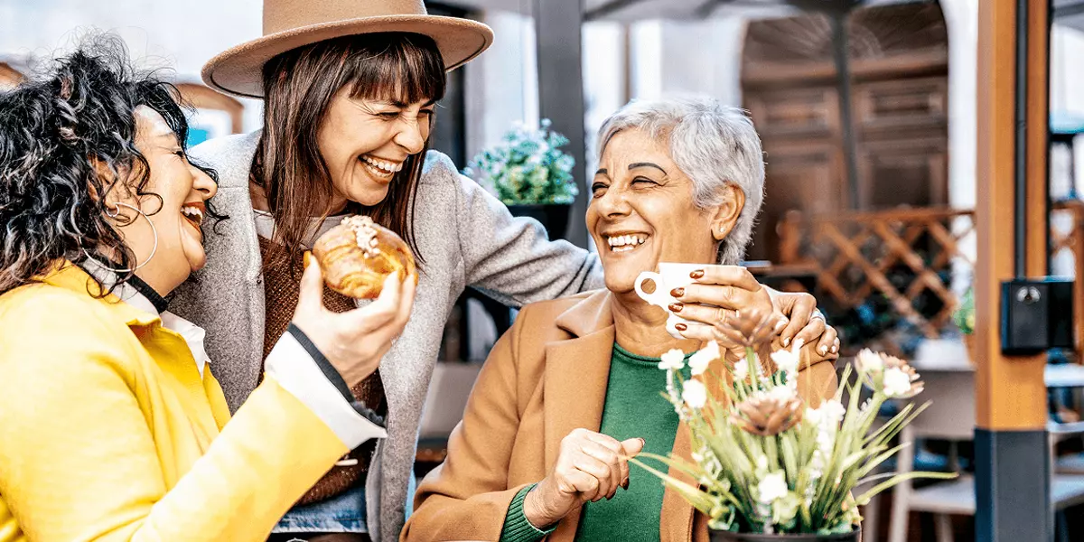 3 smiling women enjoying brunch