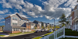 Street-view wide shot of multi-family townhomes 