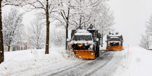 Snow plow trucks clearing the streets of snow.