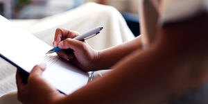 A Person compleeting an application or doucment. 