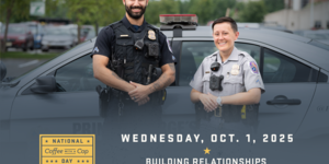 Two police officers in front of a police car. National Coffee with a Cop Day