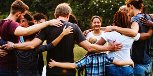 Group of Teens in a circle hugging