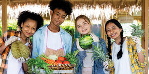 a group of teens holding different fruits in their hand