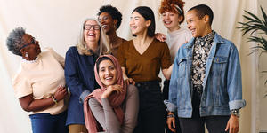 Group of women of different ages and ethnicities smiling and laughing