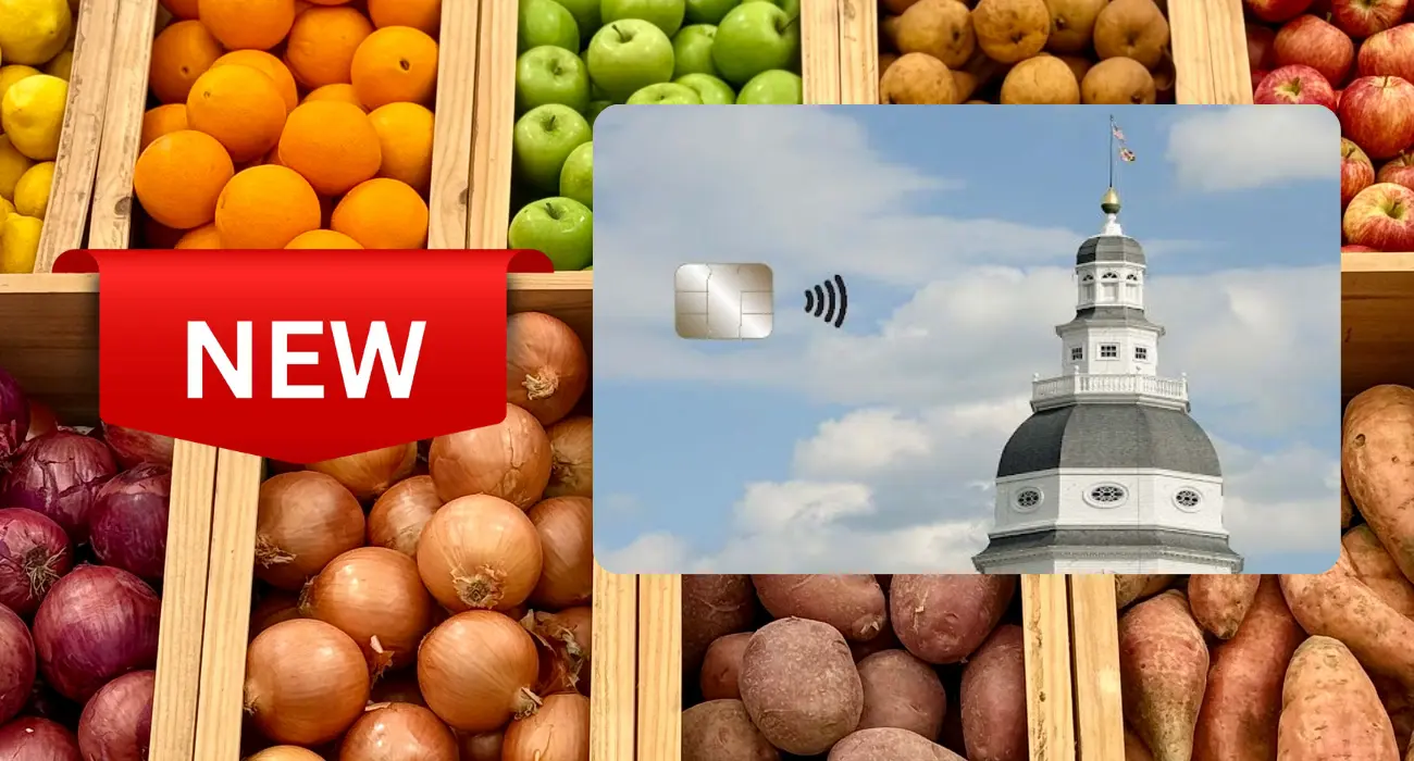 Photo cutout of new Maryland EBT Card on right and "new" flag on left Array of fruits in vegetables in wood containers on display in background