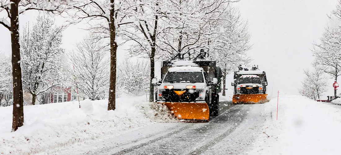 Snow plow trucks clearing the streets of snow.