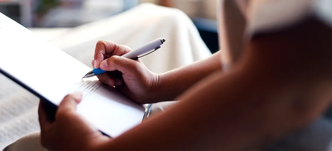 A Person compleeting an application or doucment. 