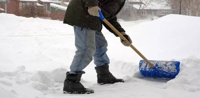 Shoveling Snow, face not shown, person scraping shovel along sidewalk