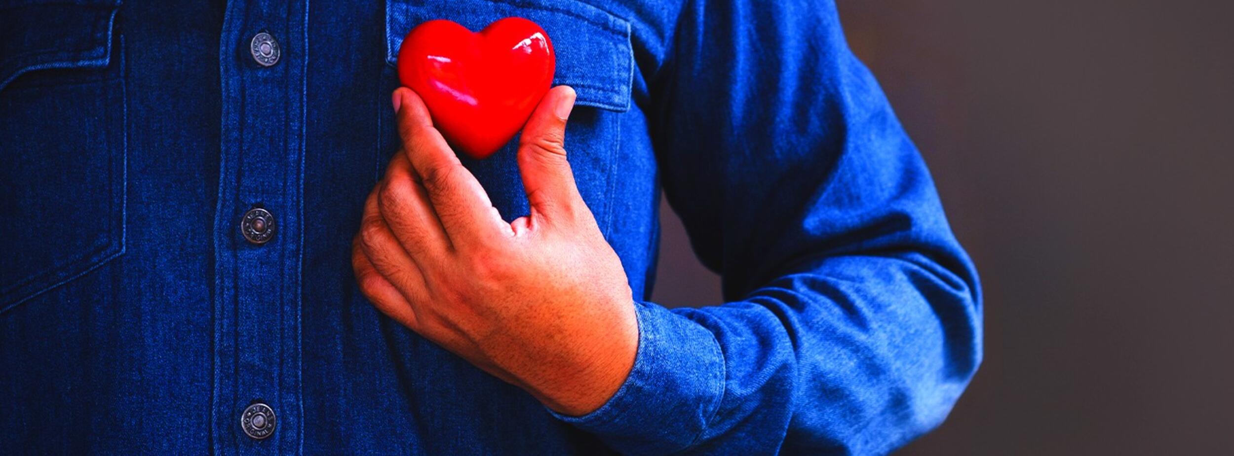 woman in a christmas sweater with her fingers rubbing the bridge of her nose appearing stressed.