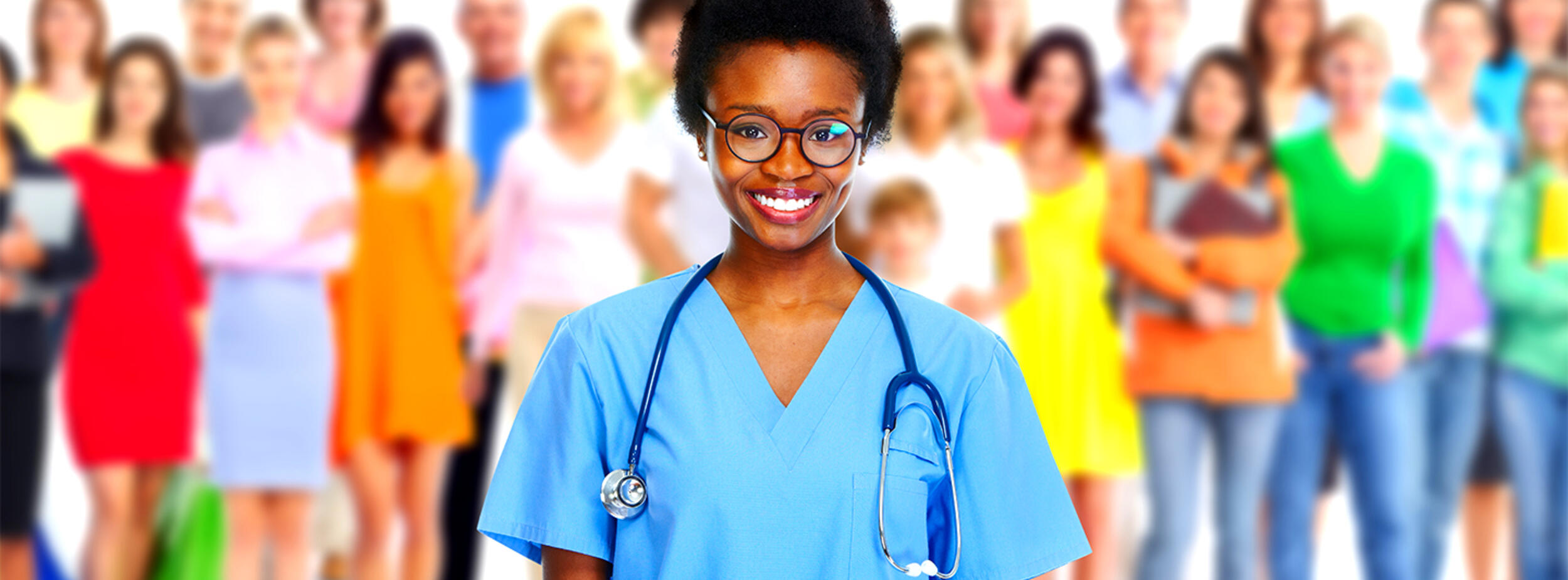 A woman who appears to be a doctor with many people in colorful clothing standing behind her
