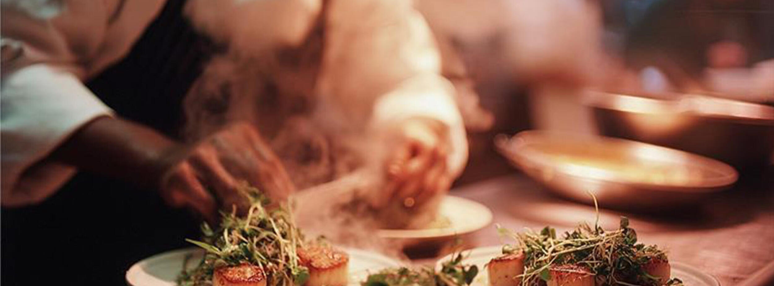 Chef preparing plates for service